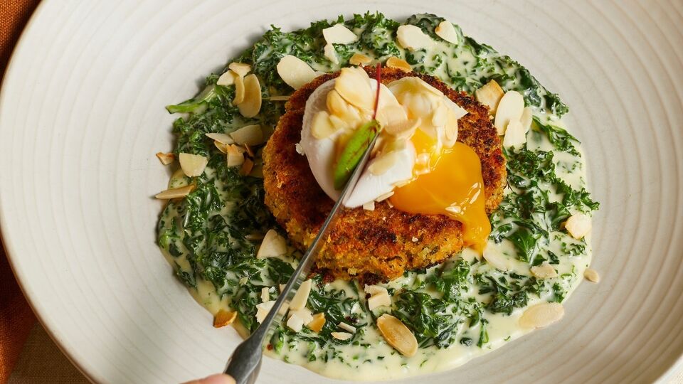 A plate of haddock fish cake with a poached egg on top