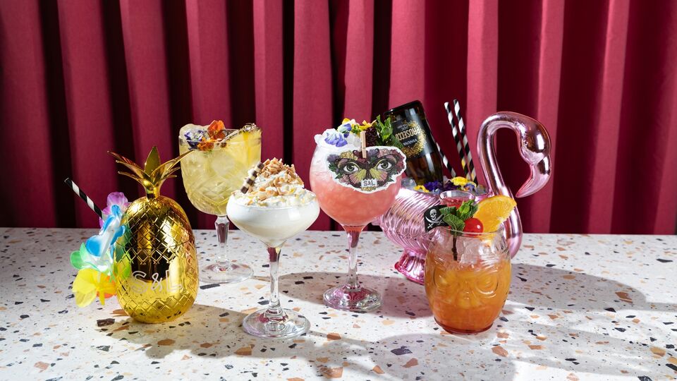 A table of colourful cocktails in extravagant glasses
