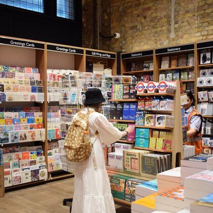 Woman shopping for gifts at foyles bookshop waterloo station