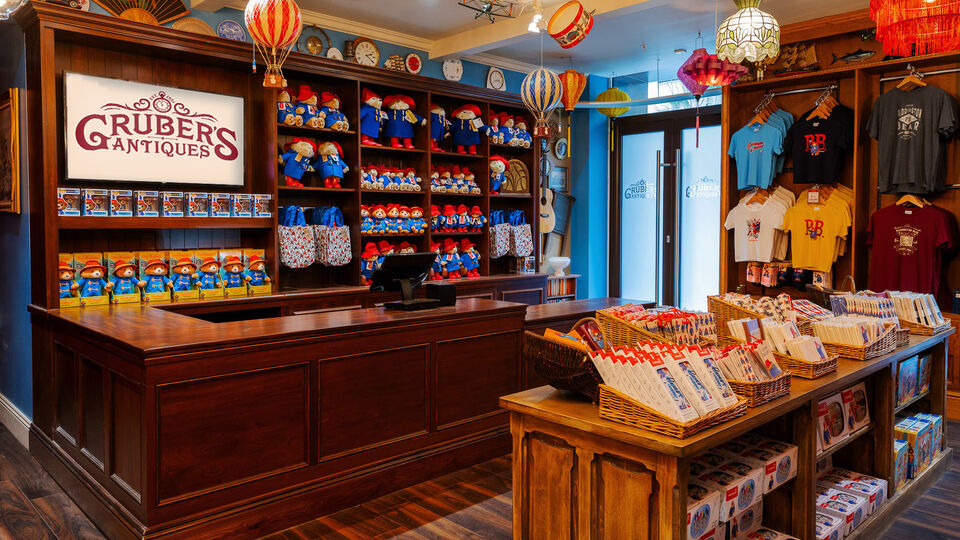 The interior of Mr Gruber's Shop at The Paddington Bear Experience at County Hall with t-shirts and toys on sale