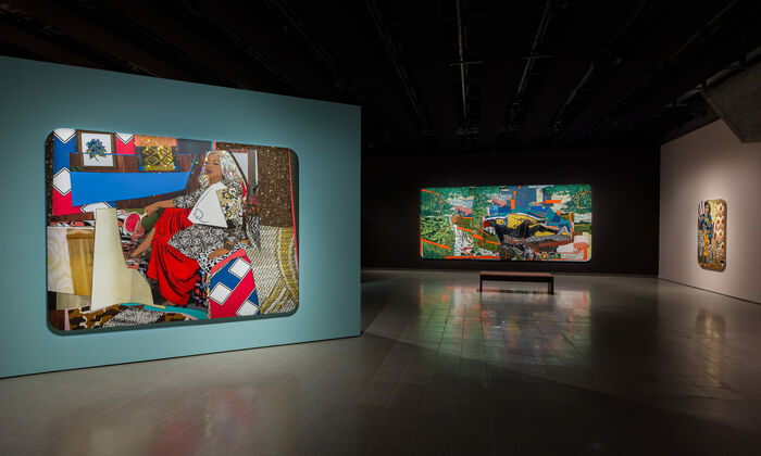 A view of art gallery with three very large canvases showing colourful portraits of women decorated with rhinestones