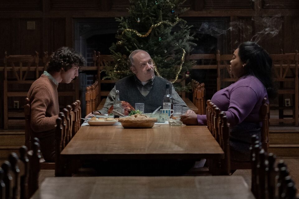 Dominic Sessa as Angus Tully, Paul Giamatti as Paul Hunham and Da’Vine Joy Randolph as Mary Lamb in director Alexander Payne’s The Holdovers. Sitting at a table at Christmas time