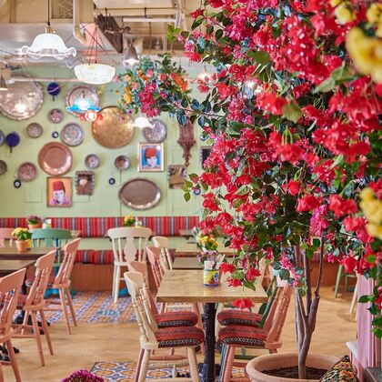 Colourful interior of Comptoir Libanais with flowers on the wall